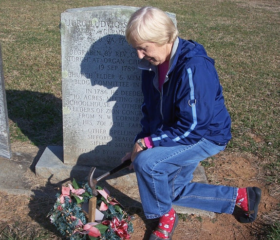 Patricia placing a Christmas Wreath Photo